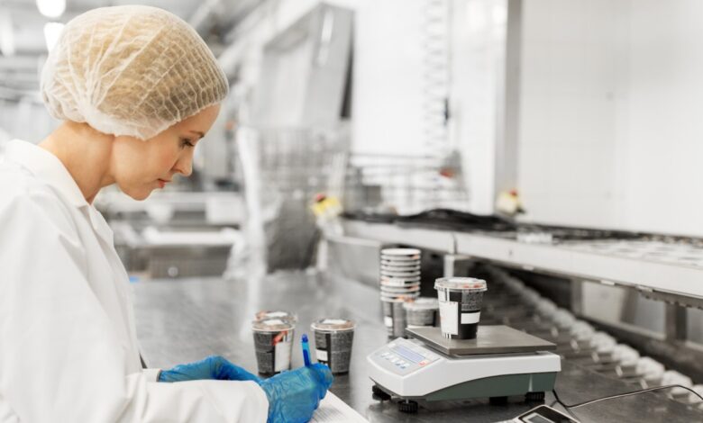 Woman working at ice cream factory pj94akq